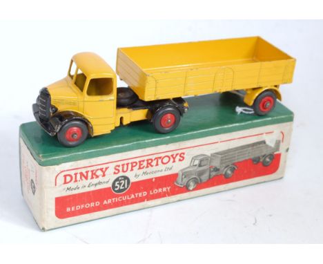 A Dinky Toys No.521 Bedford articulated lorry comprising yellow cab and chassis with yellow back and red hubs, sold in the or