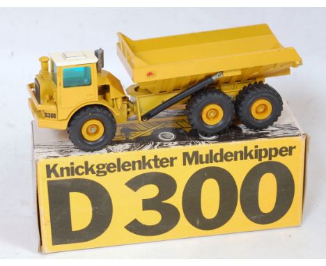 A Conrad NZG 2/50 scale boxed construction vehicle group to include an NZG No. 166 a DJBD300 articulated dump truck together 