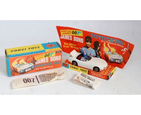 A Corgi Toys No. 336 James Bond's Toyota 2000 GT comprising of white body with black interior, and two figures, fitted with w