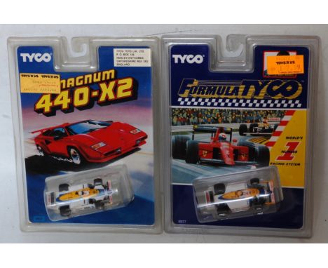 A collection of various Tyco and similar miniature scale slot racing cars to include a Honda Magnum 440-XT F1 racing car, a T