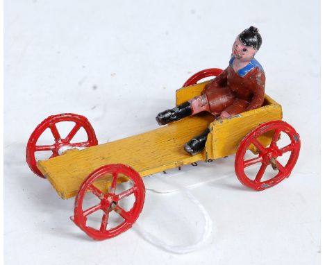 A Charbens soap box racer comprising of four wheeled open cart finished in light brown with red wheels with seated driver fig