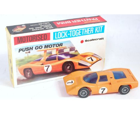 A Scale Craft Lock Together motorized kit for a Panther BRM comprising of plastic body finished in orange with racing No. 7 a