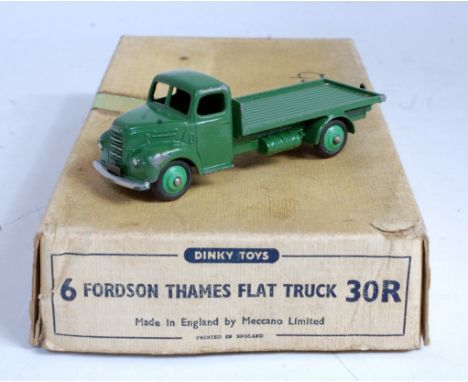 A Dinky Toys trade box No. 30R Fordson Thames flat truck containing one green example, box is heavily stained and faded