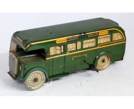 A Wells Brimtoy tinplate and clockwork Green Lines public transport bus comprising dark green and yellow body with balloon ty