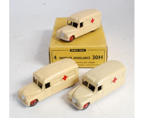 A Dinky Toys No. 30H Daimler Ambulance trade box containing three various Daimler ambulances in varying shades of cream but a