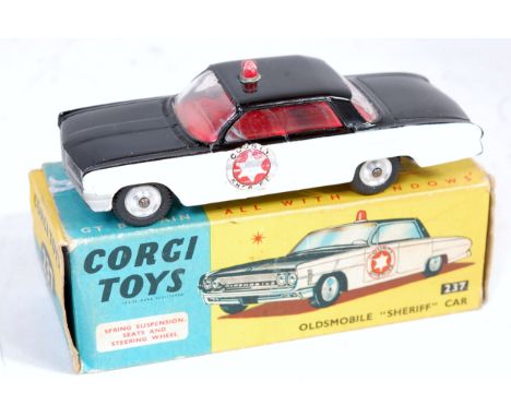 Corgi Toys, 237, Oldsmobile Sheriff Car, black and white body, with red interior, spun hubs, in the original blue and yellow 