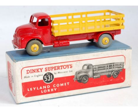 A Dinky Toys No. 531 Leyland Comet cement lorry comprising of red cab and chassis with yellow back and yellow hubs housed in 