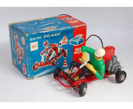 A Huki No. DM12.80 plastic and battery operated go-kart comprising of red body and chassis, with plastic driver wearing black