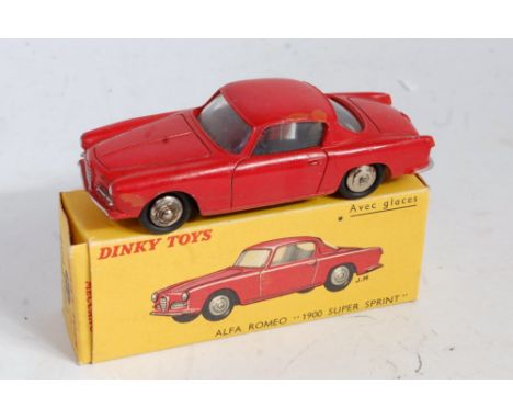 A French Dinky Toys No. 24J Alfa Romeo 1900 Super Sprint Coupe comprising red body with clear glazing and spun hubs, in the o