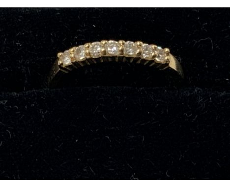 A 14ct gold half maternity ring set with CZ stones. Approximately L/M. Postage category A.