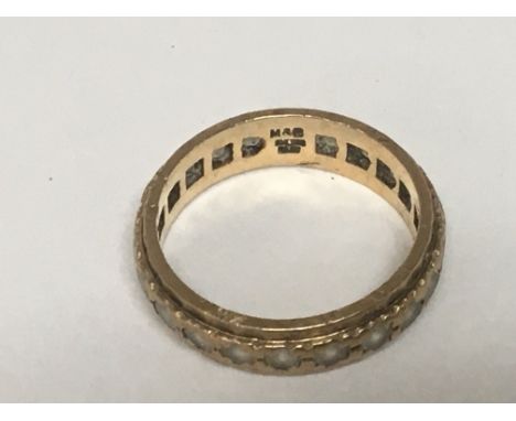 A 9carat gold eternity ring set with a single row of white stones weight 3g.
