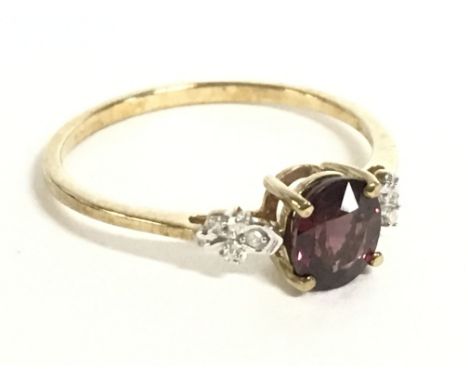 A 9 carat gold ring set with a garnet stone and small diamonds, size U, 1.9g. Postage category a