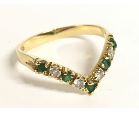 An 18ct gold emerald wishbone ring, size O. 2.5g Postage category a