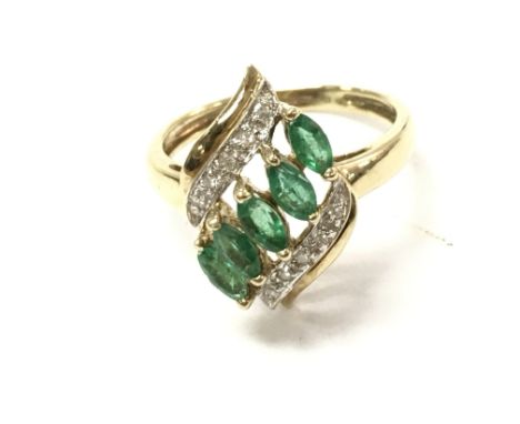 A 9ct gold diamond and emerald ring. Size O and 2.58g.