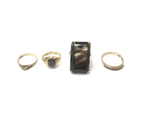 A collection of four 9ct gold rings set with various stones. 13.10g total. Postage B