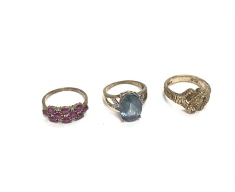 Three 9ct gold rings including a Ruby one size P a topaz size P and one other size O.11.69g