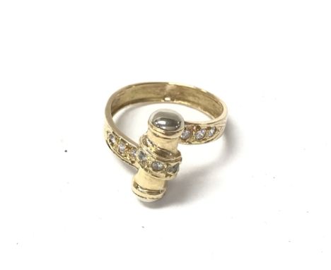 An 18ct gold ring set with white stones. Size O and 4.29g
