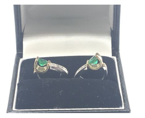 A pair of quality 14carat gold earrings of modern design white and yellow gold set with an emerald with diamonds. Weight 3g a