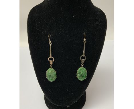 A pair of Art Deco 9ct white gold and carved jade drop earrings, 6cm drop, (A)