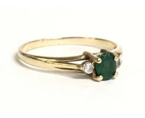 A 9 carat gold ring set with an emerald stone and small diamonds. Size P. 1.6g Postage category A