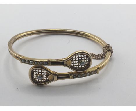 A Quality 9carat gold bracelet the ends in the form of tennis rackets and set with cultured pearls. Weight 10g approximately.