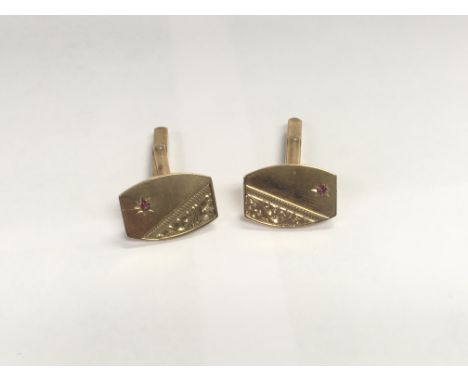 A 9ct gold ruby set pair of cufflinks. Approx 9.00 grams.