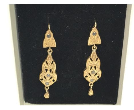 A pair of high carat gold earrings set with rose cut diamonds , total weight 2.3g. Postage category a