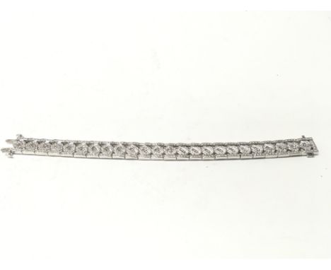 An 18ct white gold diamond bracelet. 42.07g total. 19cm long. Postage B