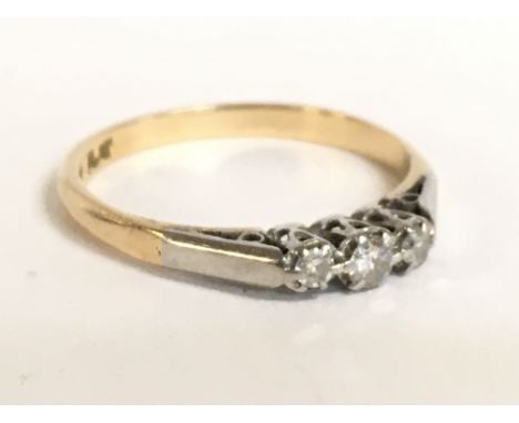 An 18 carat three stone platinum and diamond set ring. Size Q. 2.5g Postage category A