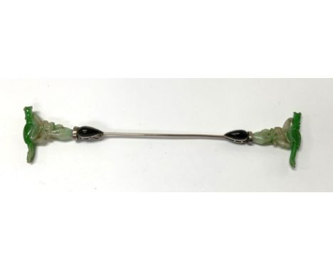 A fine quality 1920s silver Chinese hair pin set with polished obsidian and mounted either end with 2 carved jade hands and p