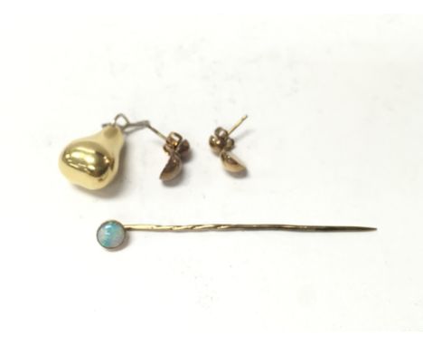 A 9ct gold stick pin set with opal and two yellow metal items. Postage A