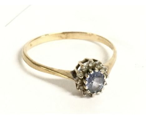 A 9 carat gold ring set with an aquamarine stone and diamond shards. Size R. 1.6g Postage category a