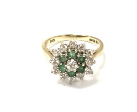 A 9ct gold emerald and diamond cluster ring. Size M 1/2 and 3.02g
