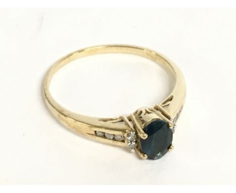 A 9 carat gold ring set with an oval topaz stone and small diamonds. Size U. 2.6g Postage category A