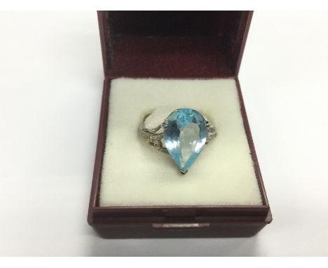 A 10k white gold ring set with a topaz, approx 4g and approx size M. Shipping category A.