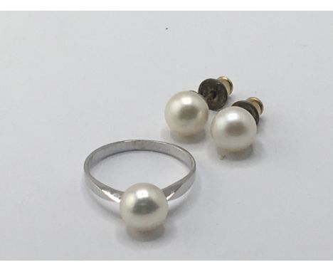 An 18carat white gold ring set with a cultured pearl weight 2g and a pair of pearl earrings.