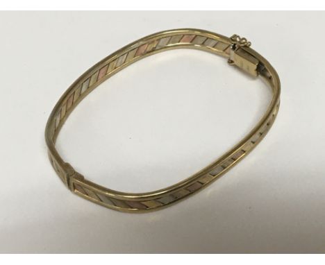 A 9carat gold tri-colour bangle. Weight 10.5g.