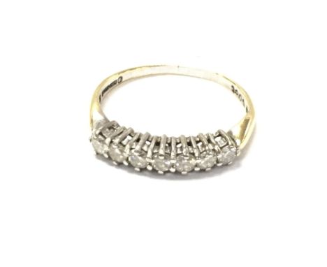 An 18ct gold ring set with seven stones. Size P and 2.39g approx 0.5ct diamond total.