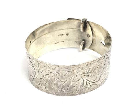 A sterling silver buckle bangle. Postage category A