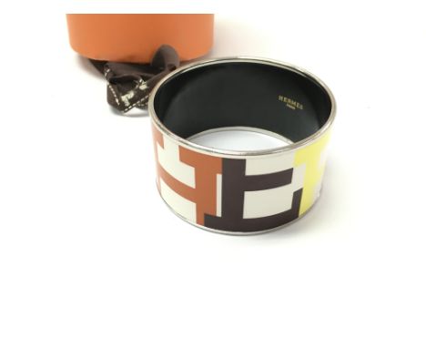 A Hermes multicolour enamel logo and metal bangle with box. Bangle is 35mm wide and 6.5cm diameter.