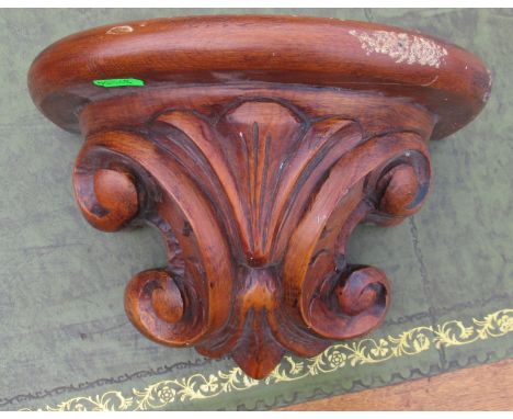 A carved wooden wall shelf, height 8ins, depth 7.5ins