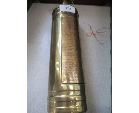 A vintage polished Pyrene fire extinguisher