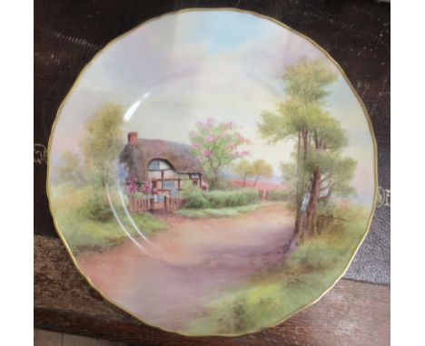 A Royal Worcester plate, decorated with a view of Harvington by R Rushton, diameter 11ins