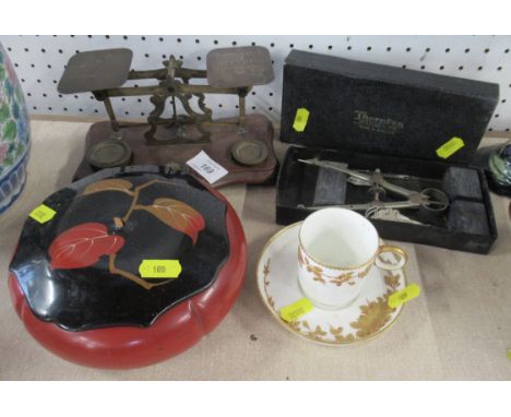 A set of postal scales, a cabinet cup and saucer, a papier mache covered pot and a boxed compass