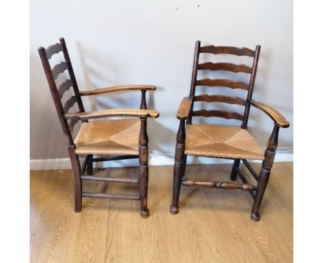 Pair of antique oak ladder back armchairs with rush seats in overall good used condition. 100cm high x 54cm deep x 58cm wide 