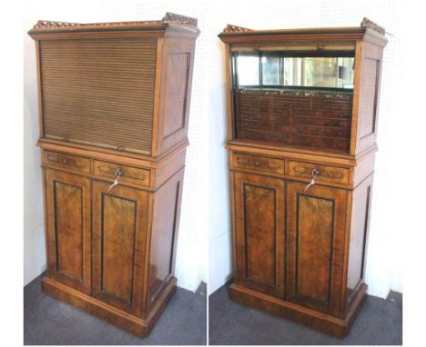 COLLECTORS CABINET, Victorian walnut with a fret carved gallery and a tambour shutter enclosing a mirrored back and sides and