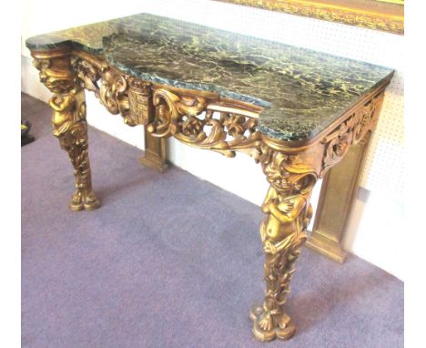 CONSOLE TABLE, Baroque style giltwood with a shaped green marble top and an Armorial heraldic frieze and leaf and scroll deco