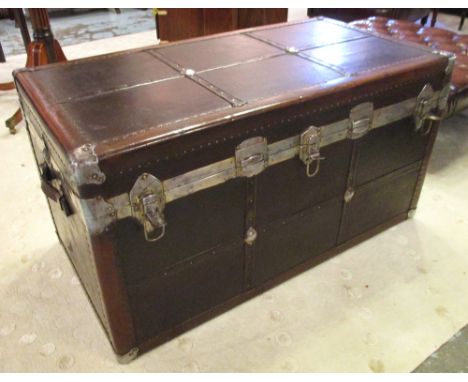 TRUNK, early 20th century tan leather and silvered metal bound with enclosed paper print lined lift out tray and side handles