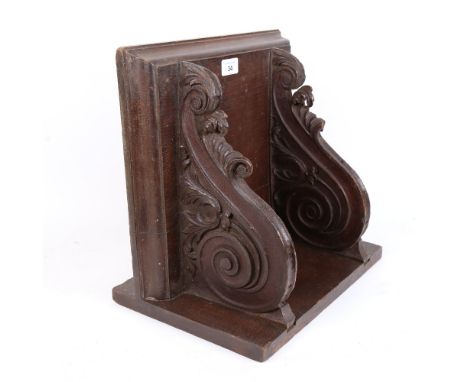 A large carved and stained oak wall bracket, with applied match striker, W36cm, D35cm, H25cm 