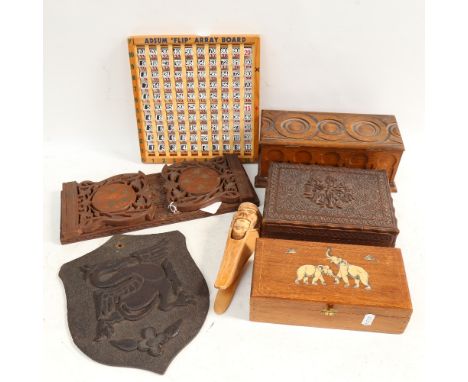 Decorative carved boxes, a shield, height 25.5cm, a carved and pierced extending bookrack, and a nut cracker etc 